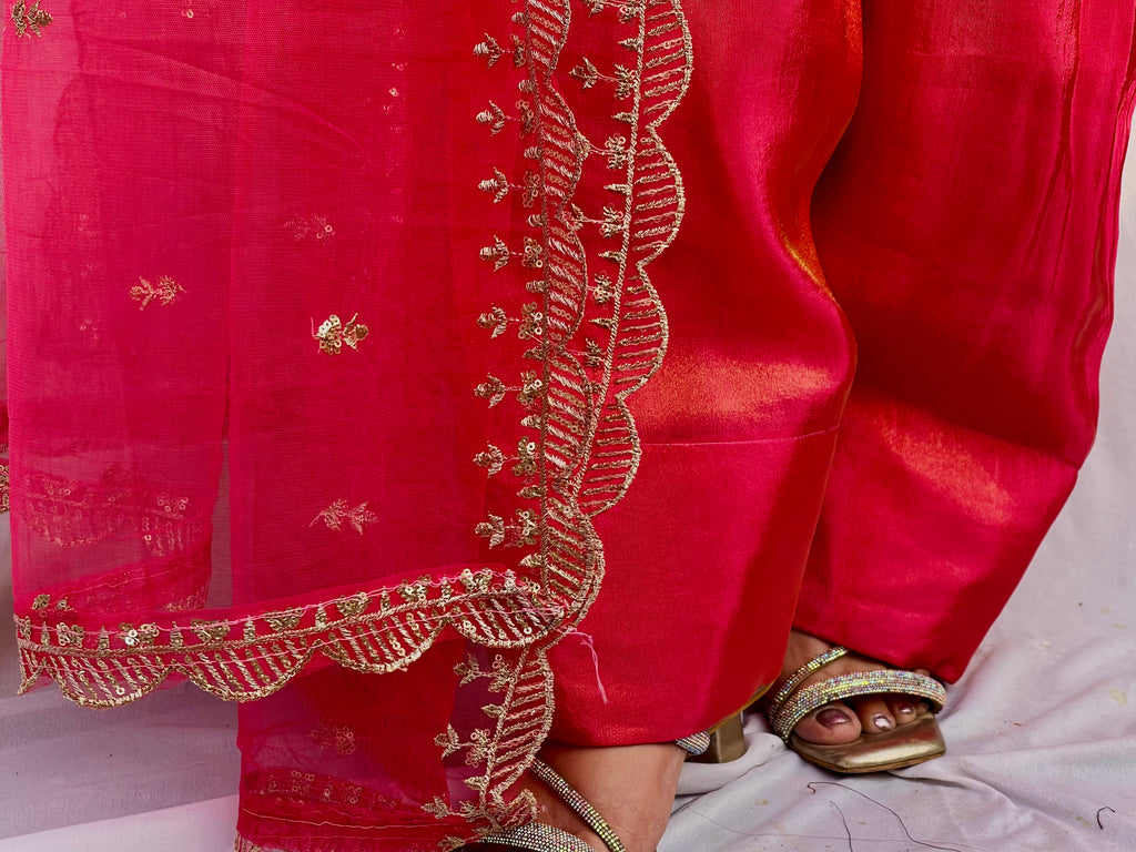 Close up of hot pink farsi embroidery and dupatta border detailing with intricate threadwork