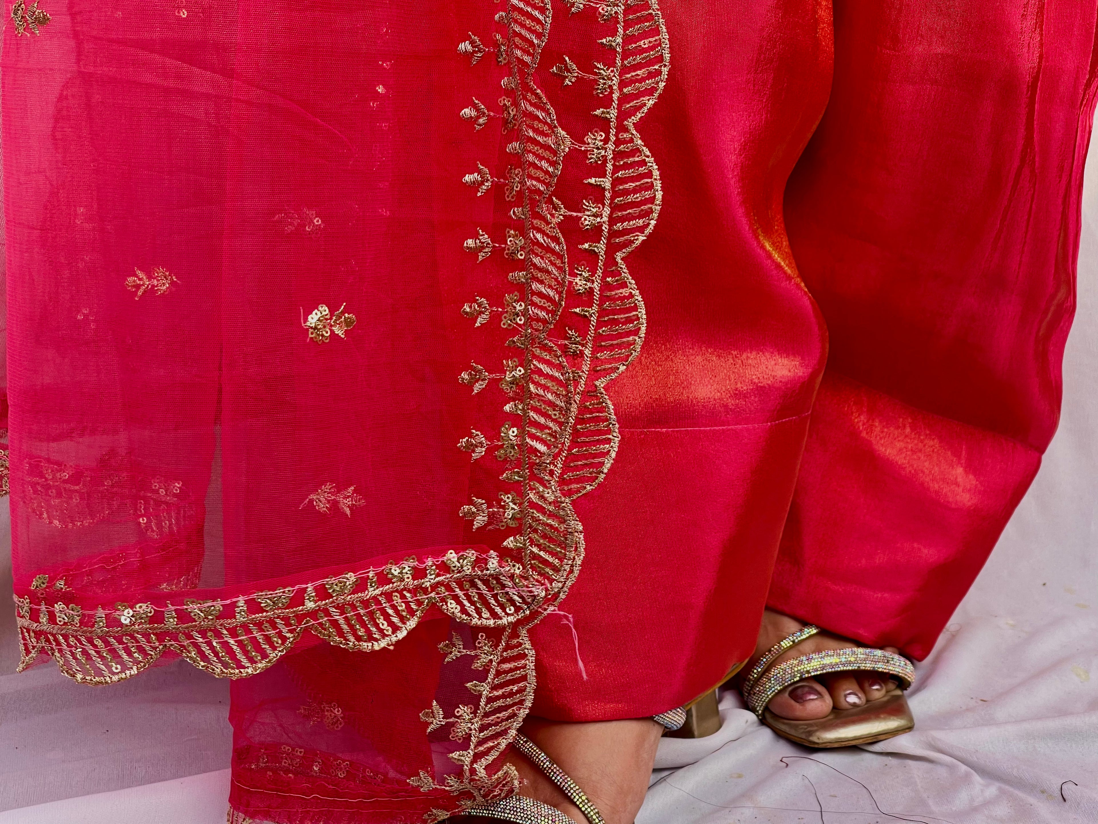Close up of hot pink farsi embroidery and dupatta border detailing with intricate threadwork