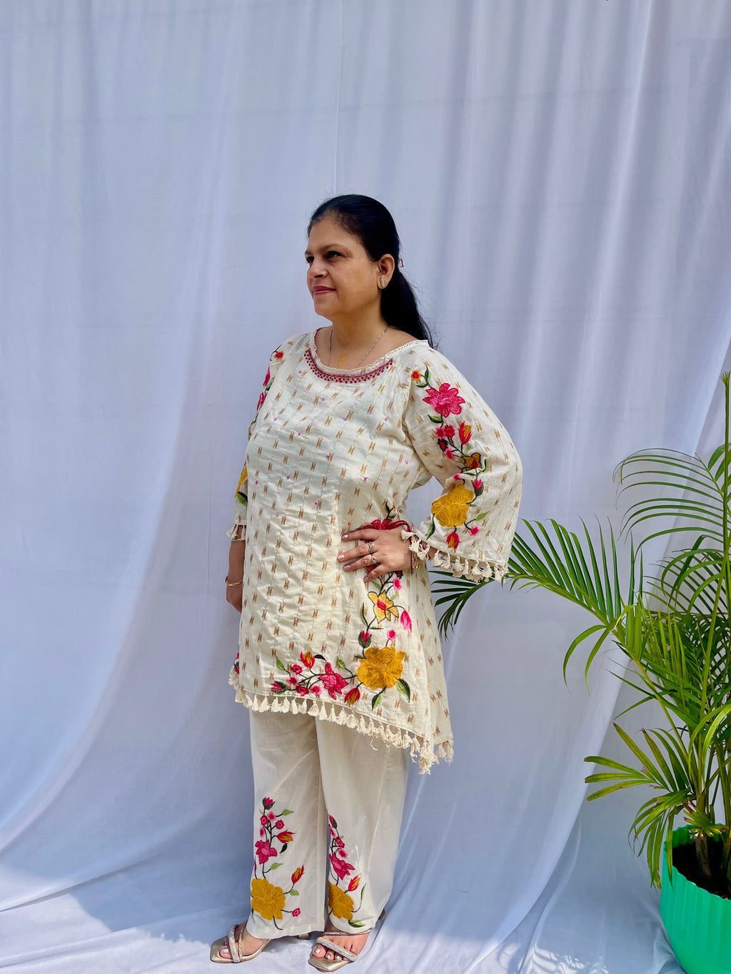 Elegant ivory white chanderi silk tunic co-ord set with large colorful floral embroidery, tassel fringe, and matching embroidered pants.