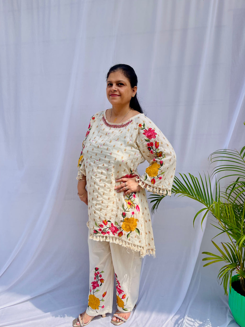 Elegant ivory white chanderi silk tunic co-ord set with large colorful floral embroidery, tassel fringe, and matching embroidered pants.