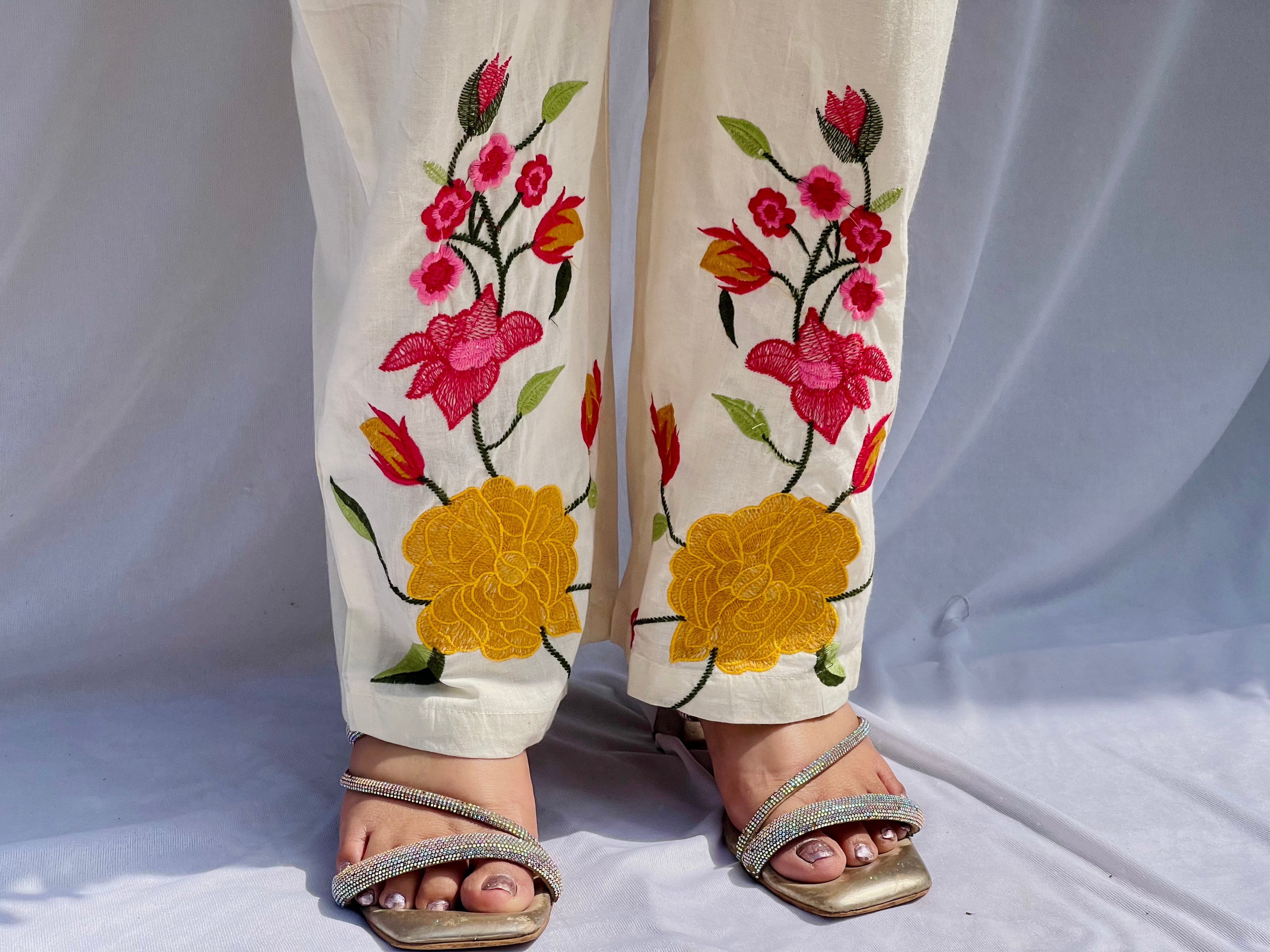Elegant ivory white chanderi silk tunic co-ord set with large colorful floral embroidery, tassel fringe, and matching embroidered pants.