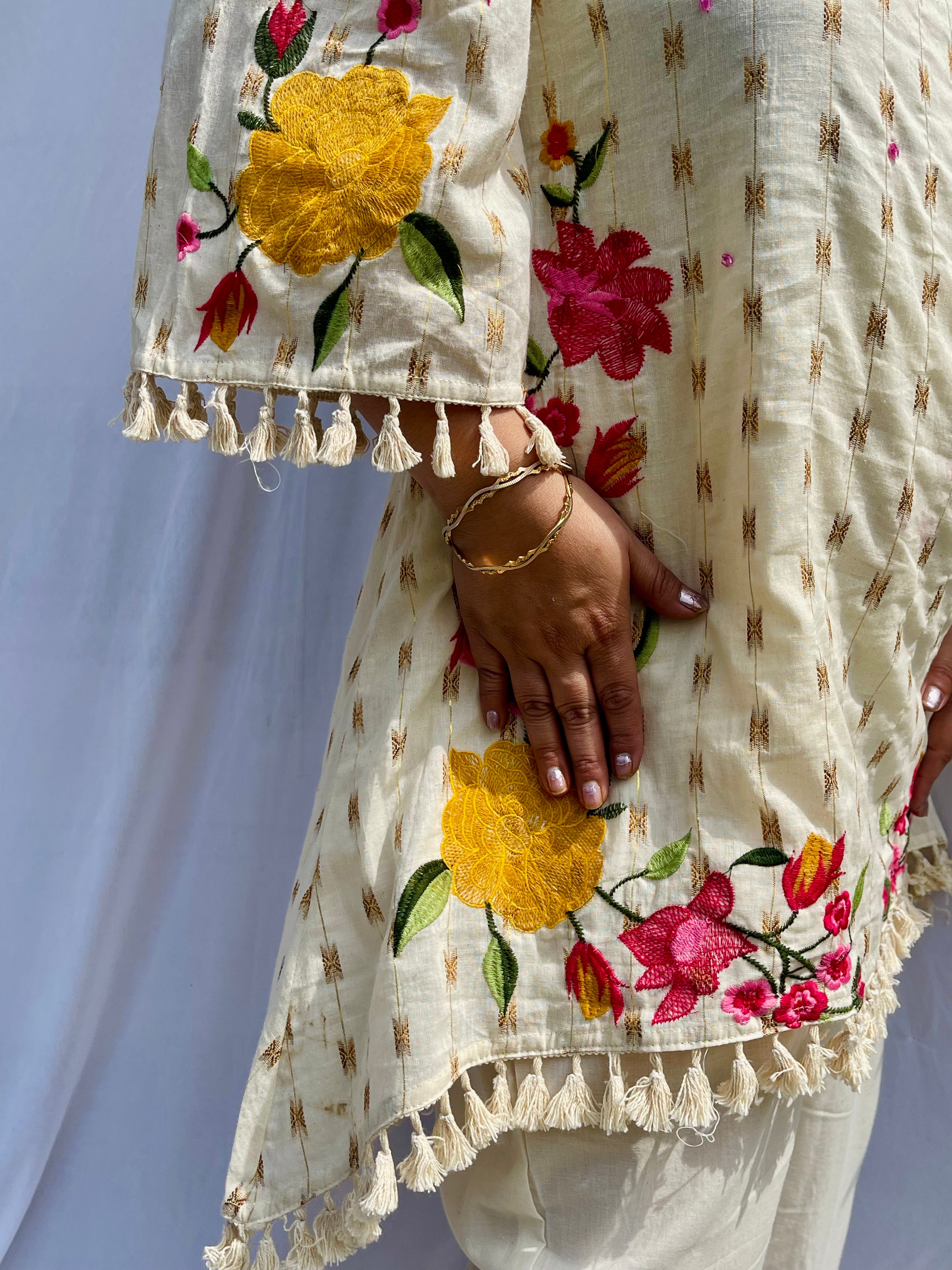 Elegant ivory white chanderi silk tunic co-ord set with large colorful floral embroidery, tassel fringe, and matching embroidered pants.