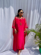 Vibrant fuchsia pink silk kaftan dress with intricate gold zardozi embroidery and crystal work on the neckline and sleeves.
