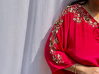 Vibrant fuchsia pink silk kaftan dress with intricate gold zardozi embroidery and crystal work on the neckline and sleeves.