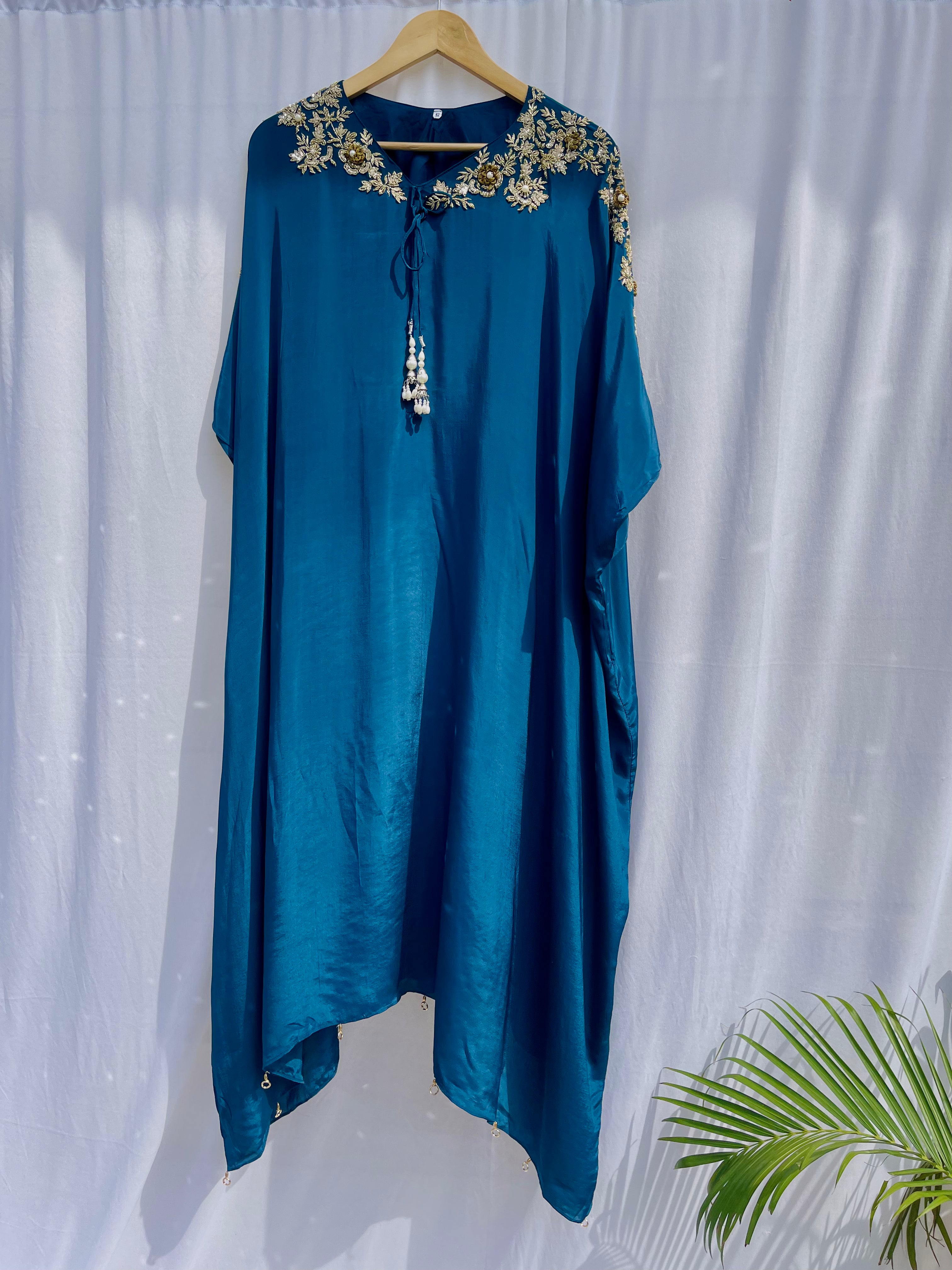 Vibrant royal blue silk kaftan dress with intricate gold zardozi embroidery and crystal work on the neckline and sleeves.