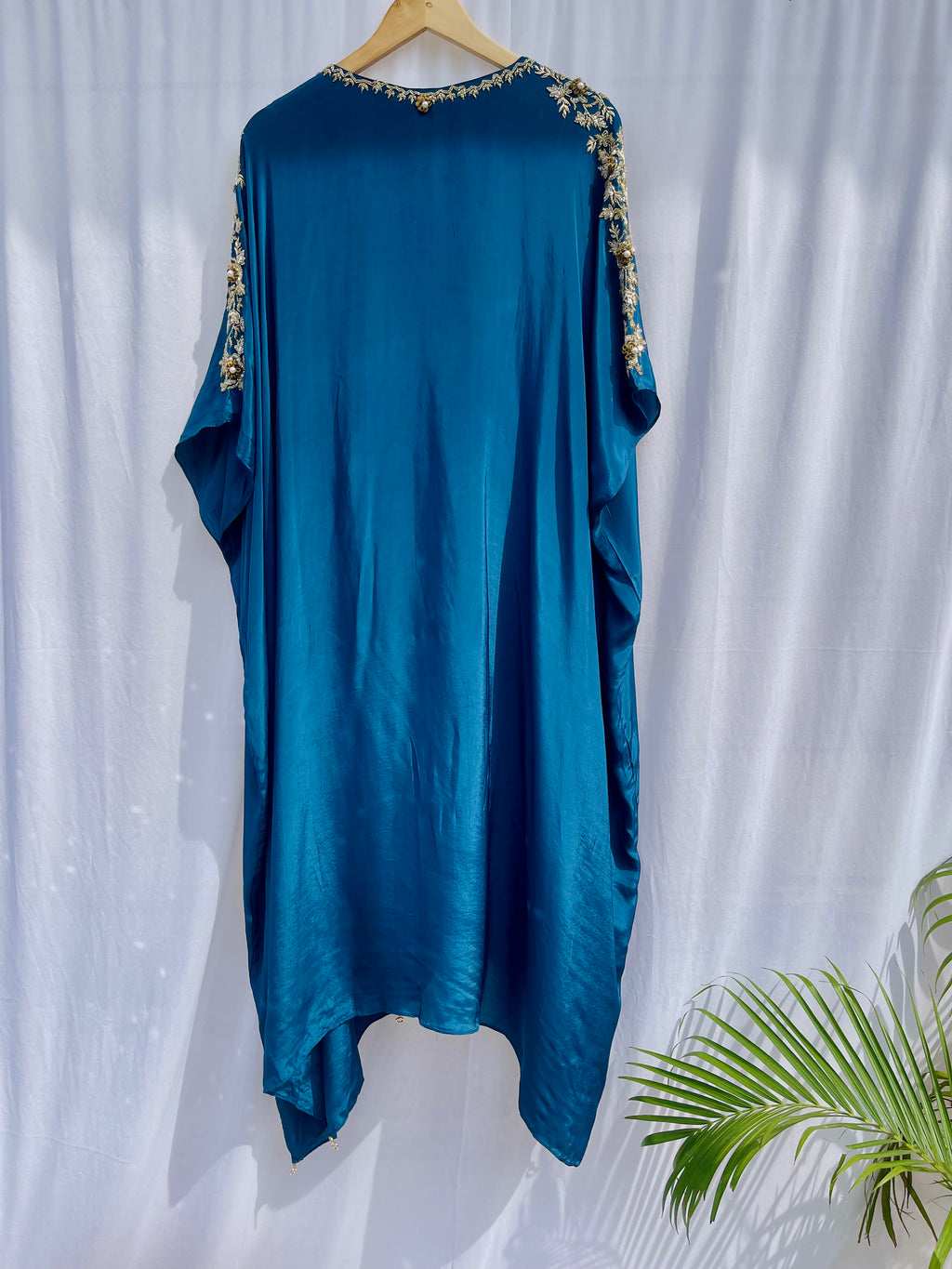 Vibrant royal blue silk kaftan dress with intricate gold zardozi embroidery and crystal work on the neckline and sleeves.