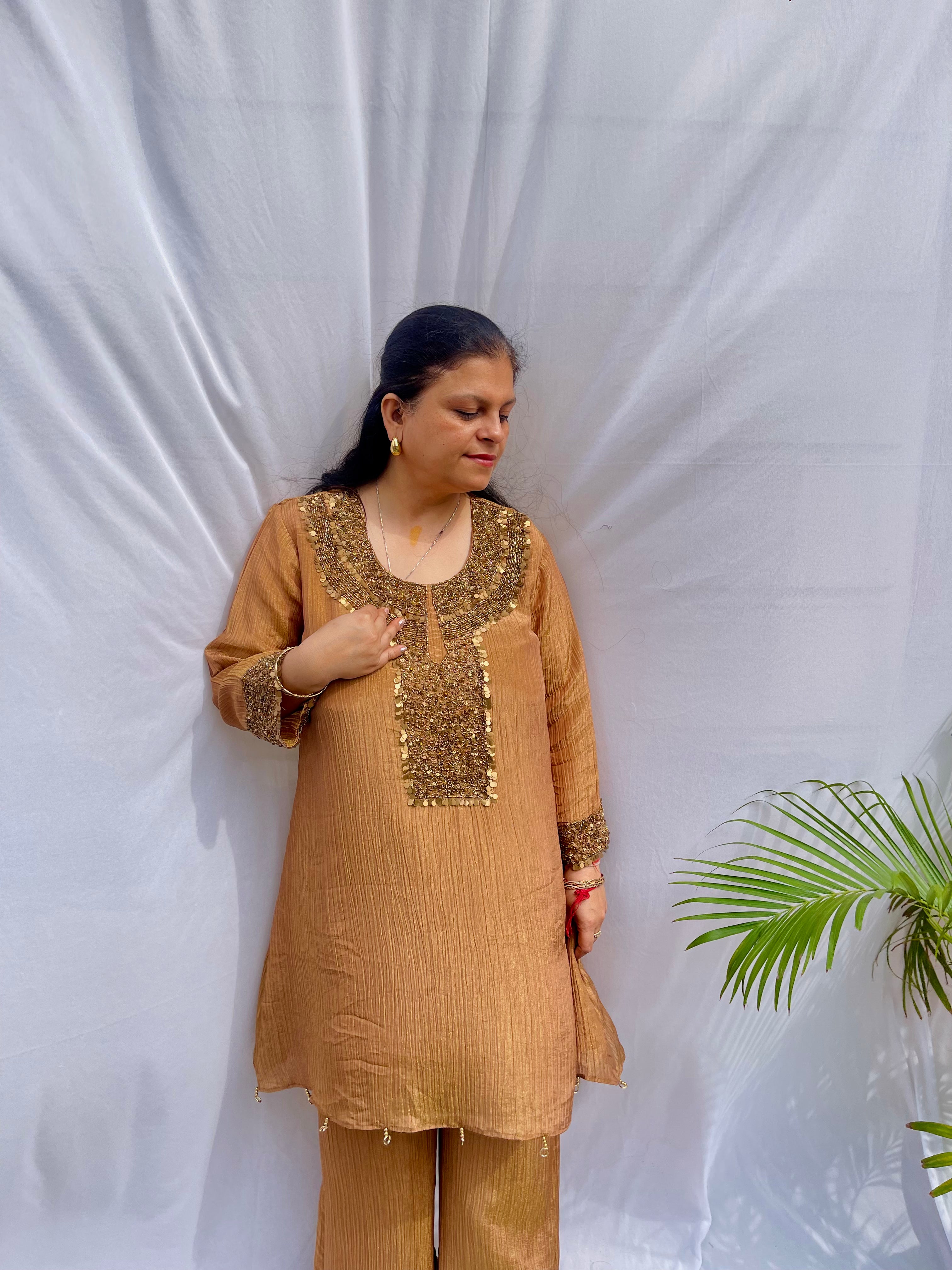 Antique gold crinkled silk ensemble with a heavily embellished sequin neckline and wide-leg flared palazzos.