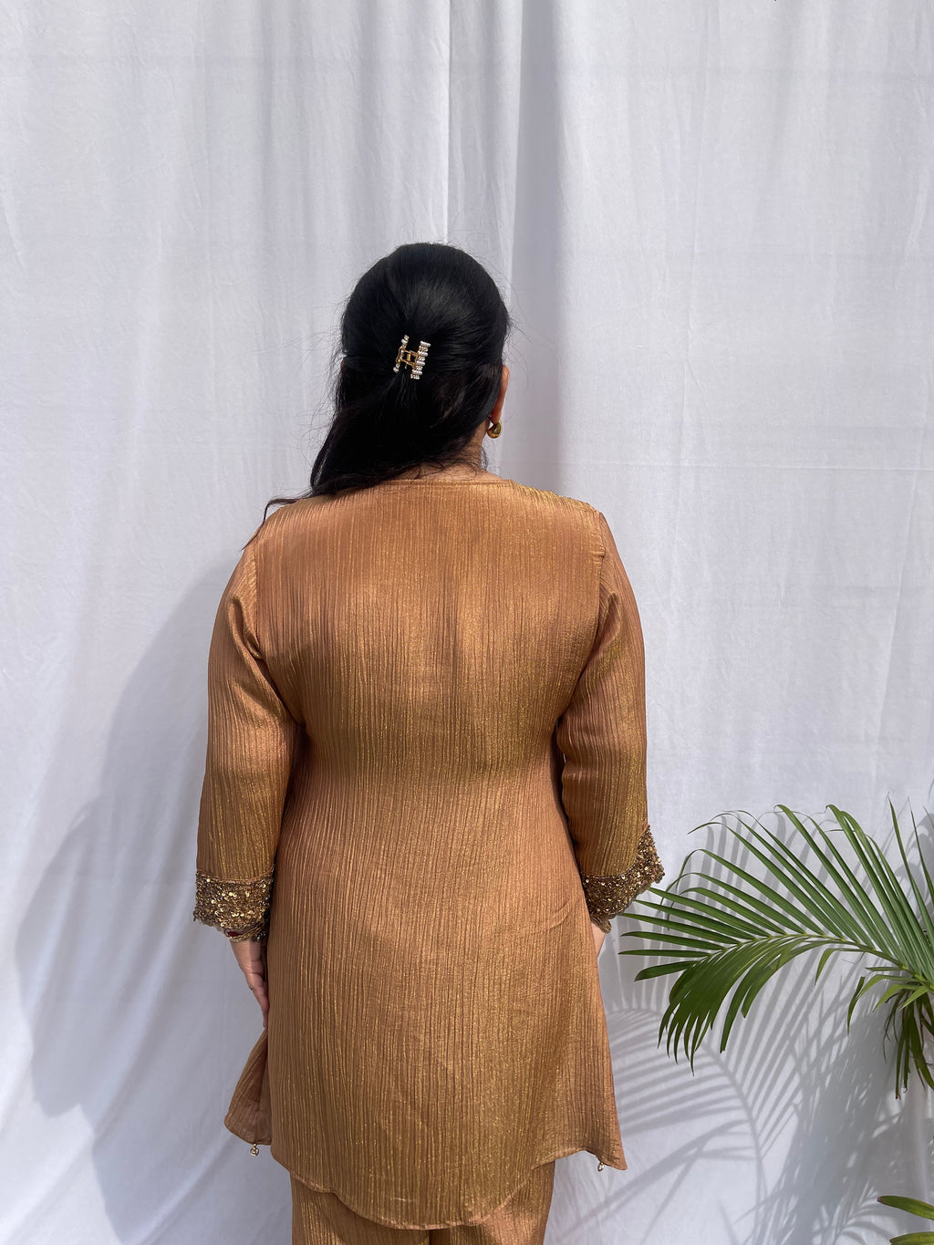 Antique gold crinkled silk ensemble with a heavily embellished sequin neckline and wide-leg flared palazzos.