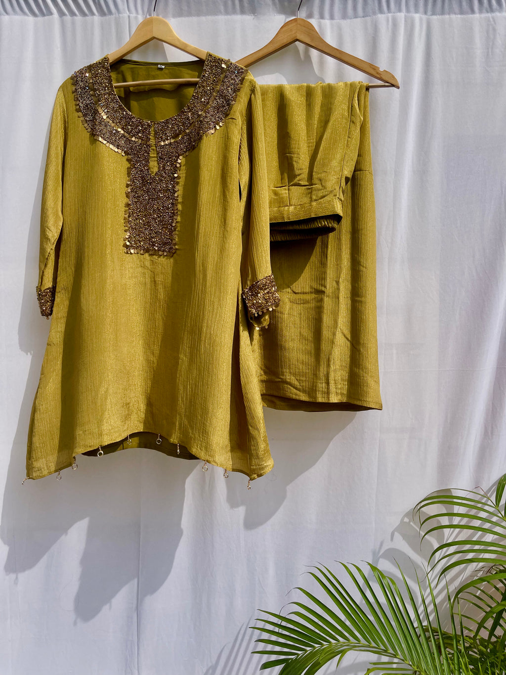 Antique green crinkled silk ensemble with a heavily embellished sequin neckline and wide-leg flared palazzos.