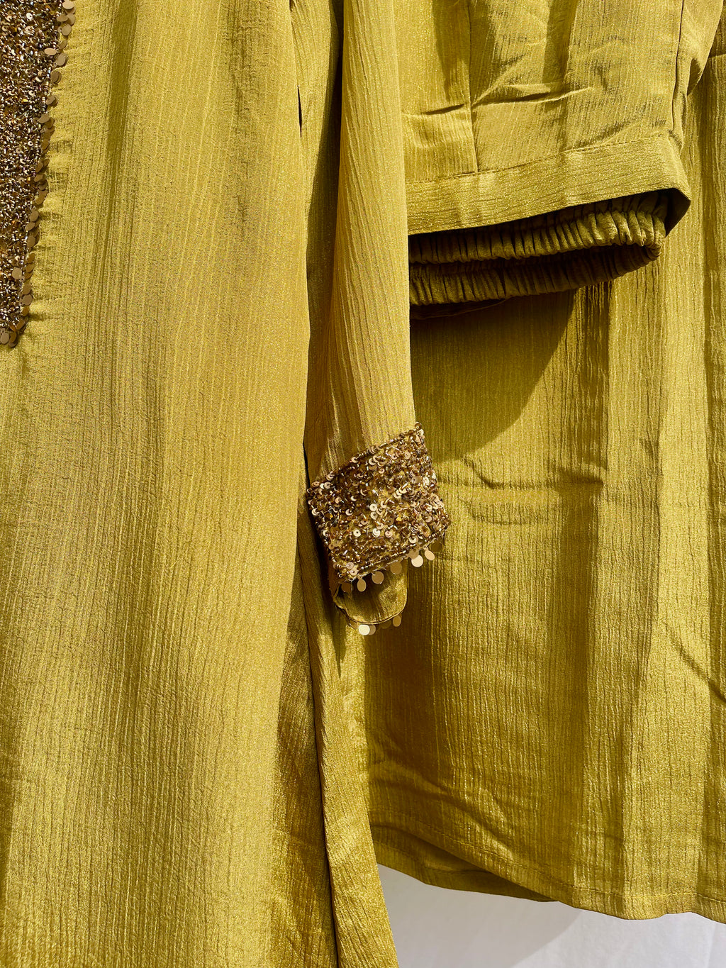 Antique green crinkled silk ensemble with a heavily embellished sequin neckline and wide-leg flared palazzos.