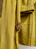 Antique green crinkled silk ensemble with a heavily embellished sequin neckline and wide-leg flared palazzos.