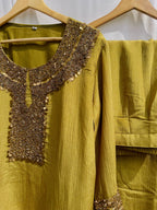 Antique green crinkled silk ensemble with a heavily embellished sequin neckline and wide-leg flared palazzos.