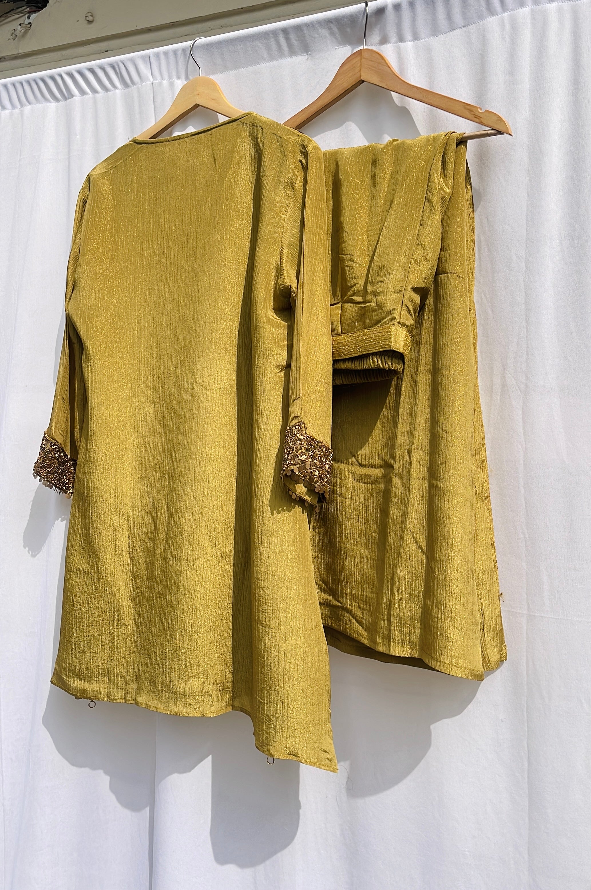 Antique green crinkled silk ensemble with a heavily embellished sequin neckline and wide-leg flared palazzos.