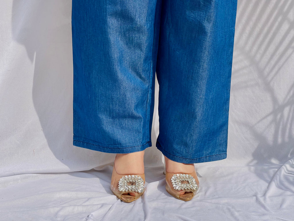 Denim-finish indigo blue shirt set with a large white leaf thread-work embroidery on the right shoulder and sleeve.