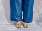 Denim-finish indigo blue shirt set with a large white leaf thread-work embroidery on the right shoulder and sleeve.