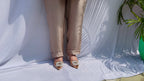 Shiny champagne gold satin co-ord set featuring a short-sleeved shirt with heavy pearl and bead embellishments on the shoulders.