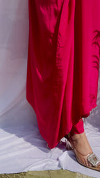 Vibrant fuchsia pink silk kaftan dress with intricate gold zardozi embroidery and crystal work on the neckline and sleeves.