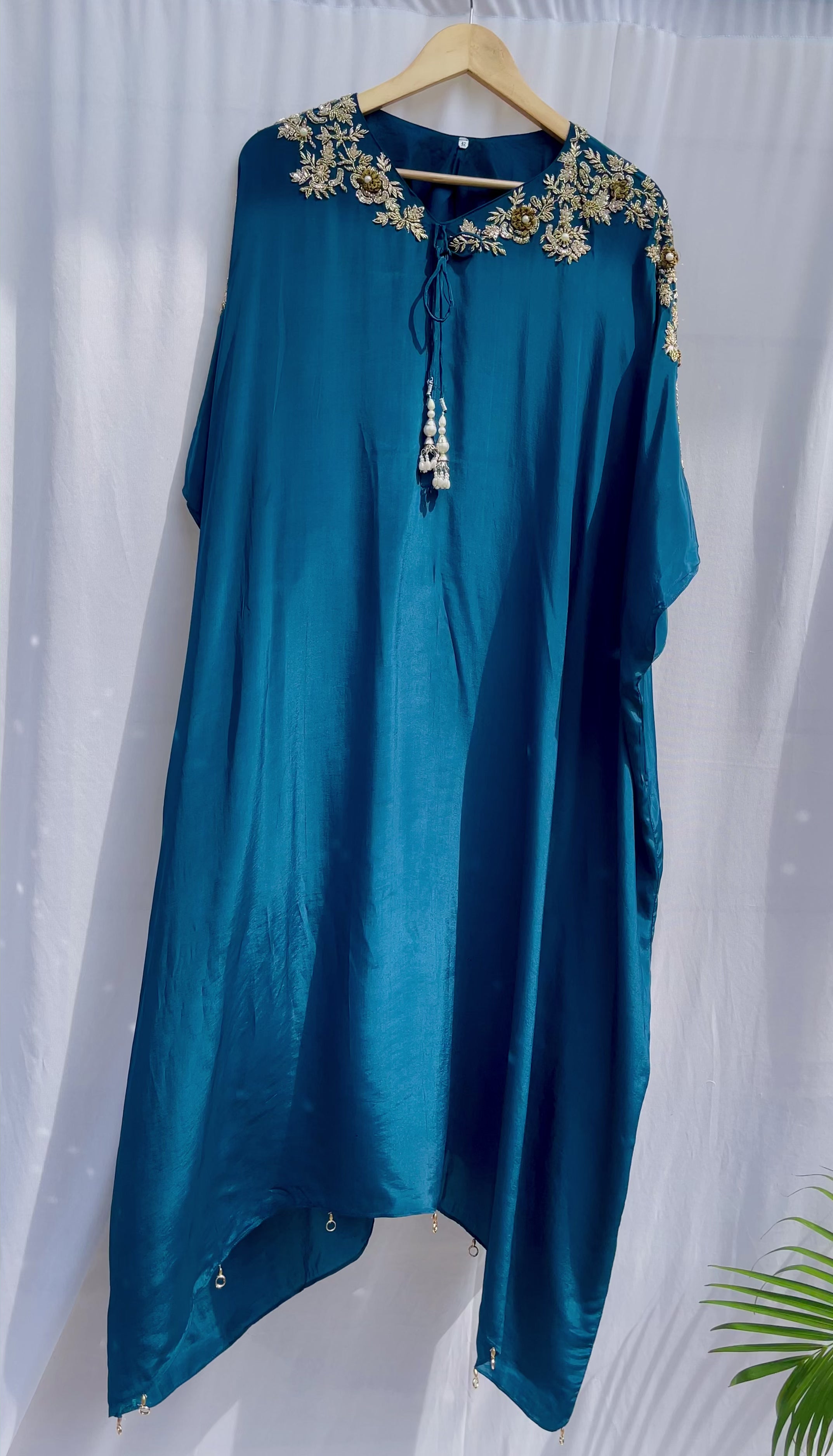 Vibrant royal blue silk kaftan dress with intricate gold zardozi embroidery and crystal work on the neckline and sleeves.